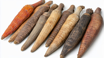 A collection of whole dried long pepper, with their rough, elongated texture, arranged on a white background