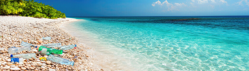 Obraz premium Beautiful beach polluted with plastic waste, clear turquoise waters contrasting with litter, highlighting environmental issues.