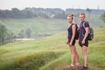 Hiking couple enjoys scenic view while taking a break in nature