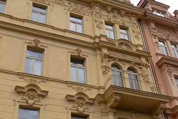 There is a large and modern building that has an elegant balcony and an abundance of windows that let in plenty of natural light