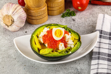 Avocado with red caviar and quil egg