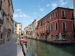 Canal and old buildings on a sunny day in Venice, Italy.