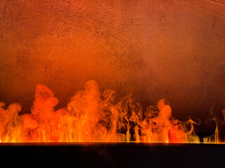 Bright flame against a concrete wall