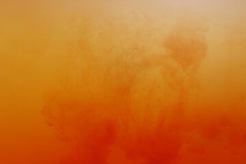 Orange color dye melt on white background,Abstract smoke pattern,Colored liquid dye,Splash paint	