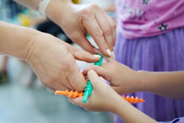 children's hand and teacher hand in the classes of developmental