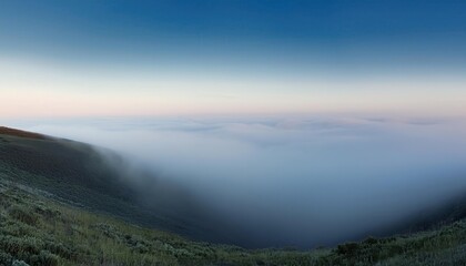 Frosty Winter Dawn Over a Misty Valley. Ethereal Landscape of Frost Covered Fields and Bare Trees Shrouded in Morning Fog, Capturing Tranquility and the Subtle Blue Hues of a Crisp, Quiet Sunrise