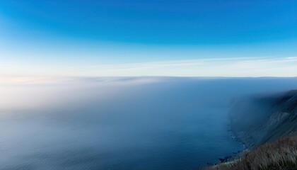Frosty Winter Dawn Over a Misty Valley. Ethereal Landscape of Frost Covered Fields and Bare Trees Shrouded in Morning Fog, Capturing Tranquility and the Subtle Blue Hues of a Crisp, Quiet Sunrise