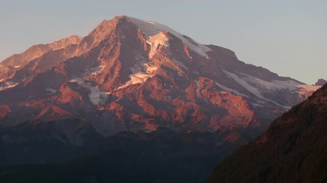 Sunset light illuminating Mount Rainier with glaciers and rugged terrain, Washington State, USA