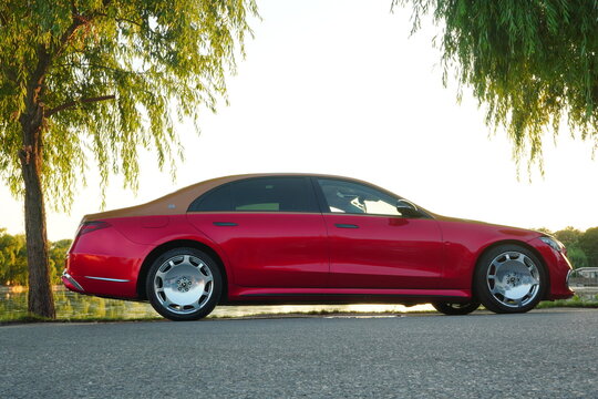 Mogosoaia, Ilfov, Romania - July 28, 2024: Mercedes Maybach new red car parked on Mogosoaia Lake shore 
