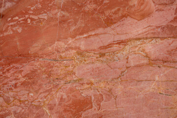 Polished red marble texture featuring unique natural patterns, perfect for wall or floor design.