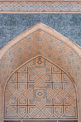 Traditional tile ornament on archway in Bukhara showcasing traditional Islamic geometric patterns. Uzbekistan
