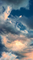 Colorful evening clouds form a stunning pattern in the sky, bathed in warm sunset light.