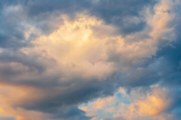 Golden and blue clouds at sunset create a dramatic sky with soft, warm lighting.