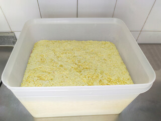 Flaked instant mashed potatoes at plastic fiber container
