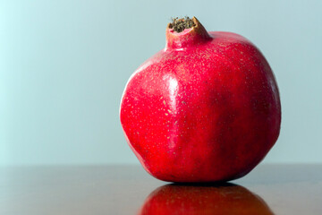 Whole pomegranate isolated on neutral background