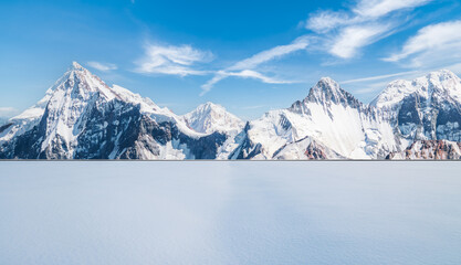 White snow ground and spectacular snow mountain nature landscape in winter. car advertising background.