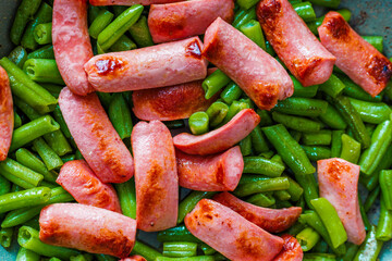 closeup full-frame high angle view background of roasting sausages with green beans
