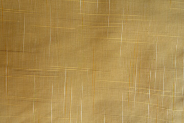 Top view of sand yellow checkered cotton fabric