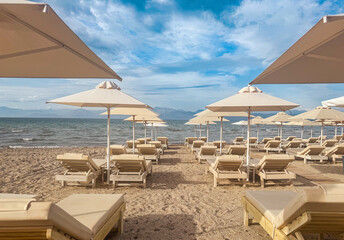 Beach chairs and umbrellas Roda Corfu with views of Albania