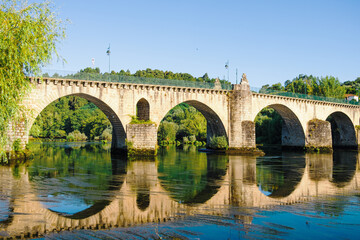 Old Stone bridge over the Lima river in Ponte da Barca. Portugal