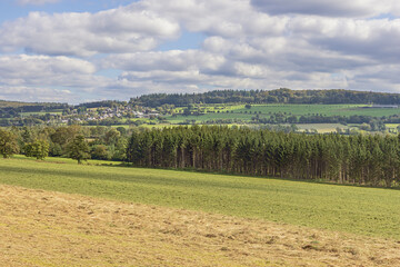 Agricultural land and small villages in the rolling hills near Marche-en-Famenne, a region known for agriculture and forestry