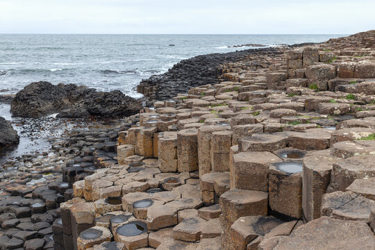 Basalt columns of Giant Causeway on the Northern Irish coast. Hexagonal stones leading toward the Atlantic Ocean shore