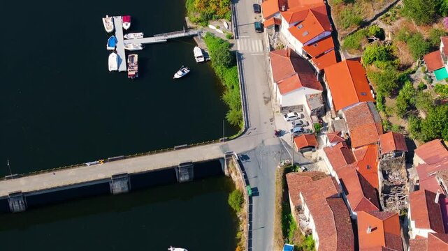 Typical Houses And Vineyards On Banks Of Minho River Near Ponte de Belesar In Lugo, Spain. aerial shot
