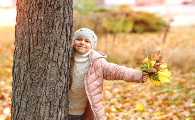 Cute Caucasian girl walks in the autumn park. Vacations. Autumn concept