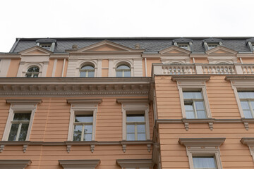 A significantly large building featuring numerous large windows and a prominent balcony that enhances its overall aesthetic appeal
