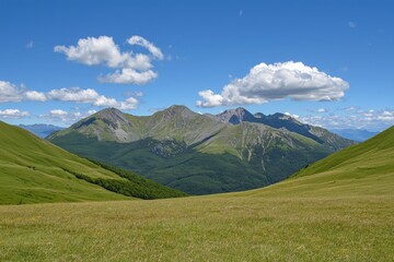 Naklejka premium Vast green valleys under a clear blue sky with majestic mountains in the background