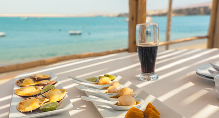 A table with a variety of food and a glass of beer