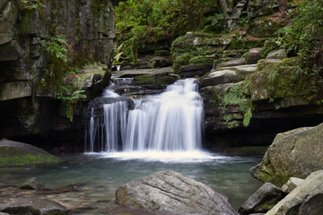 Fototapeta premium color detail photography of beautiful small waterfall in the forest
