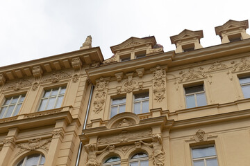 As I gaze upward at the towering large building that boasts a multitude of windows, I cant help but admire its grand facade