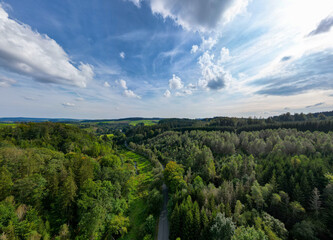 Obraz premium Belscher Aifel, Lengeler, Burg-Reuland, Liege, Belgium, 22nd of September, 2024, A breathtaking aerial view showcasing the stunning vibrant greenery and the beautiful cloudy skies above