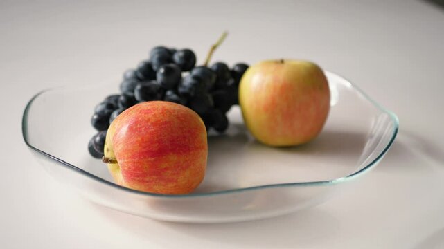 Hand Takes Ripe an Apple From a Bowl of Fruit . Healthy Gmo Free Food