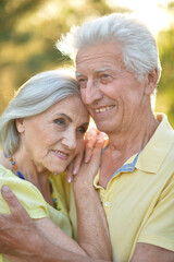 Portrait of beautiful senior couple posing in the park