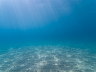 Underwater photo, azure sea with sandy bottom in the South of France.