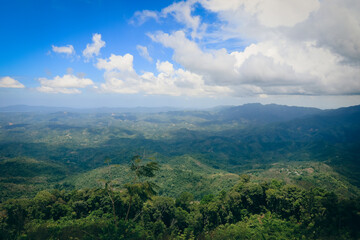 A stunning view of lush green hills and vibrant blue skies in Kota Kinabalu during a clear afternoon