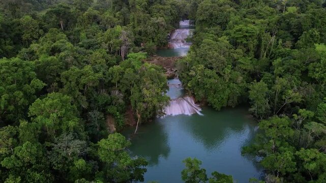 Aerial drone footage over river and waterfalls surrounded by lush jungle, Roberto Barrios, Chiapas, Mexico