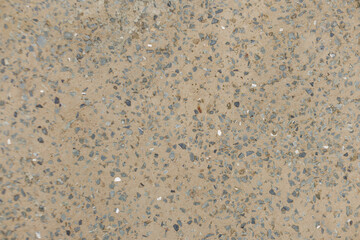 Close up view of a concrete sidewalk showing small stones embedded in the cement Karlin, Prague