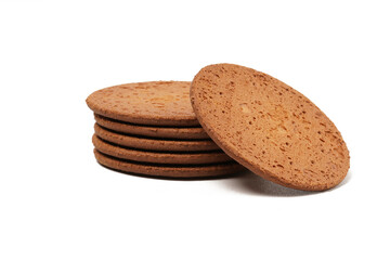 Round, flat chocolate-flavored crackers with a brown color, neatly stacked. Perfect as a snack. Photographed on a white background.