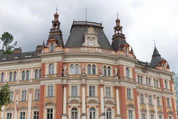 A large, impressive brick building that boasts a clock prominently positioned on the very top of its structure, showcasing its grandeur and charm