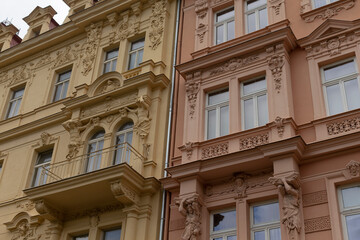 There is a tall building featuring numerous windows located right next to another impressive structure that is also filled with many windows