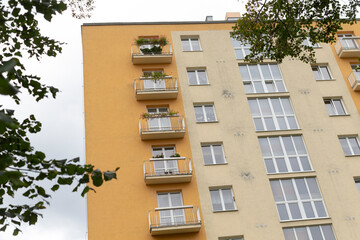 A very tall building boasting an extensive array of windows and numerous balconies, reflecting modern urban architecture and design