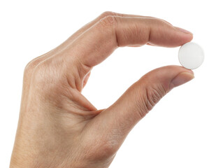 Fototapeta premium Close-up of hand holding a white round pill between fingers, isolated on transparent background, medical concept of medication, healthcare, and pharmaceutical treatment