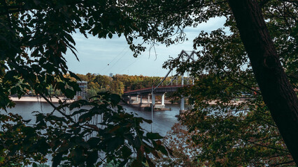 Framed by Nature: Kyiv’s Bridge Through Autumn Trees