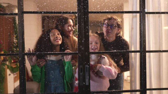 Parents and a teen girl on Christmas night with the first snowfall