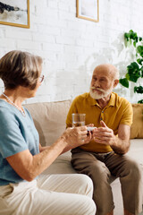 A devoted wife assists her husband with diabetes, showcasing love and support in their home.