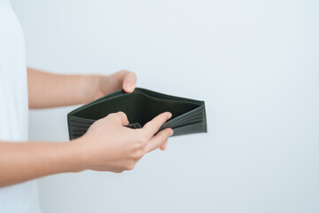 Woman hand holding and open empty wallet with not have banknote money. Crisis, loan, bankrupt and debt financial concept.