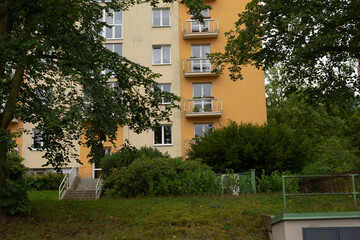 An impressive tall building featuring numerous windows and several spacious balconies that enhance its architectural appeal and charm